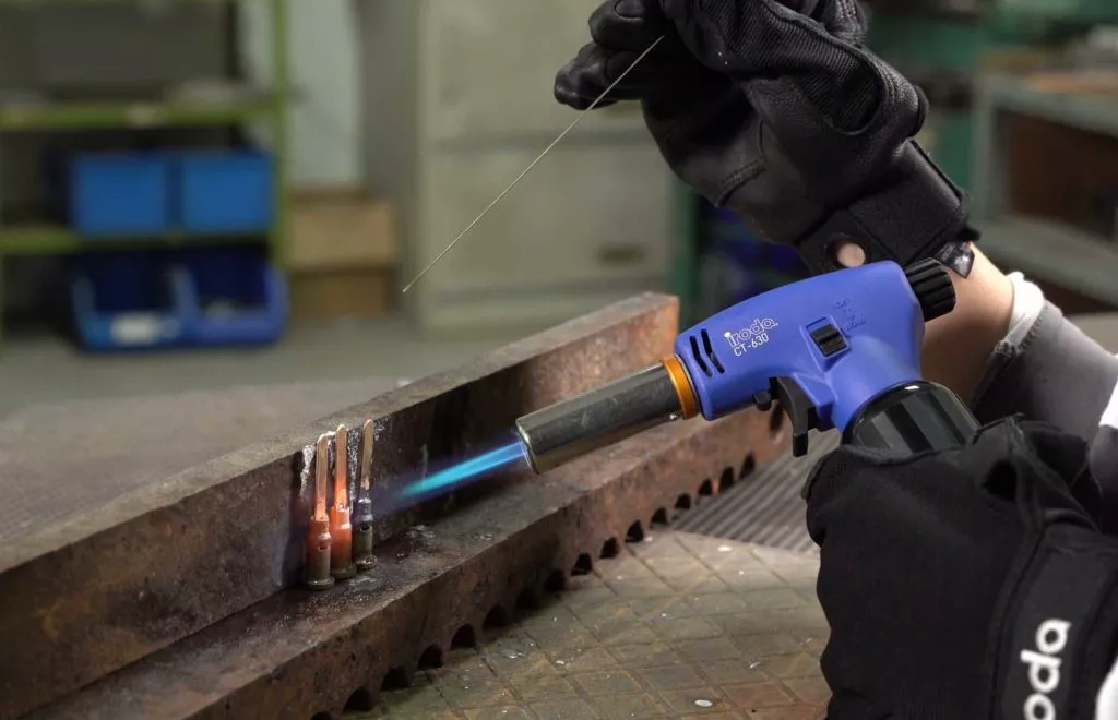Pro-Iroda's CT-630 Professional Butane Torch with high output flame performing heavy duty welding in a factory