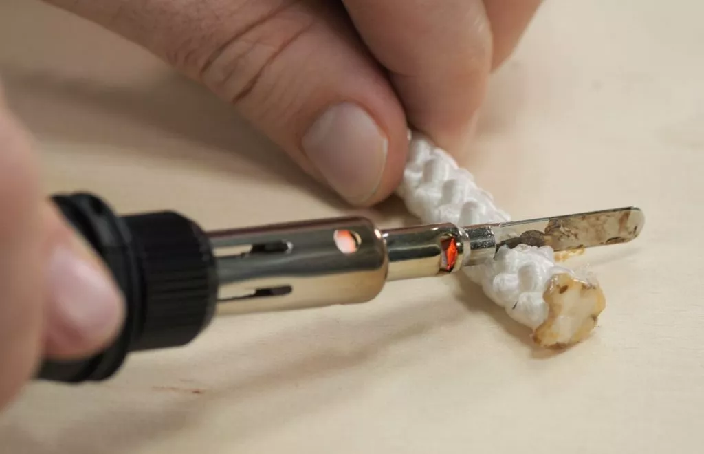 Hot knife effortlessly slicing through marine rope